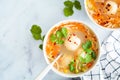 Potato balls soup with noodles and vegetables in white bowl, white background. Vegan food concept Royalty Free Stock Photo