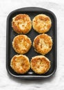 Potato bread crumbs baked cakes on a baking tray on a light background