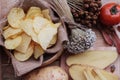 Potato chip and fresh potatoes on wood background Royalty Free Stock Photo