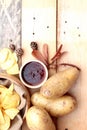 Potato chip and fresh potatoes on wood background Royalty Free Stock Photo