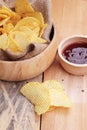 Potato chip and fresh potatoes on wood background Royalty Free Stock Photo