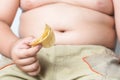 Potato chip in obese fat boy hand Royalty Free Stock Photo