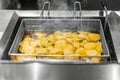 Potato chip deep frying in hot oil