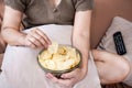 potato chips addiction with unhealthy woman hand eating salty and oily potato fries