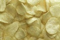 Potato chips background in the sunlight. White, golden. Royalty Free Stock Photo