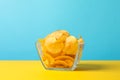 Potato chips. Beer snacks on yellow background against blue background Royalty Free Stock Photo
