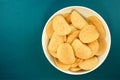 Potato chips on a blue background, top view