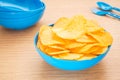 Potato chips in bowl on table Royalty Free Stock Photo