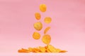 Potato chips fly on a pink background. Levitation. Royalty Free Stock Photo