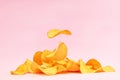 Potato chips fly on a pink background. Levitation. Royalty Free Stock Photo