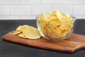 Potato chips in a glass bowl on a table.  Macro view Royalty Free Stock Photo