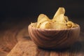 Potato chips with herbs in wood bowl on rustic table Royalty Free Stock Photo