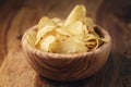 Potato chips with herbs in wood bowl on rustic table Royalty Free Stock Photo