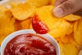 Potato chips and ketchup. Beer snack, unhealthy eating Royalty Free Stock Photo
