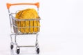 Potato chips on mini shopping cart on white background