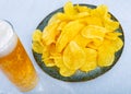 Potato chips served with glass of beer Royalty Free Stock Photo