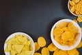 Potato chips and snacks on black slate table, top view Royalty Free Stock Photo