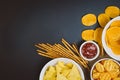 Potato chips and snacks on black slate table, top view Royalty Free Stock Photo