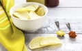 Potato chips on white glass bowl with spoons of mustard and red pepper. Royalty Free Stock Photo