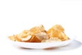 Potato chips on a white plate isolated on a white background. Selective focus Royalty Free Stock Photo