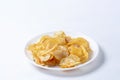 Potato chips on a white plate isolated on a white background Royalty Free Stock Photo