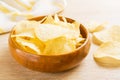 Potato chips in wooden bowl on table Royalty Free Stock Photo