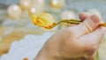 Potato cookies on a gold fork in the chef's hand. Potato cookies canonic recipe Brie, parmesan and Heavy cream