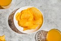 Potato crisps served in a white bowl, beer snacks on a gray background