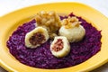 potato dumplings filled with smoked meat with fried onion on red cabbage Royalty Free Stock Photo