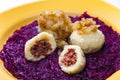 potato dumplings filled with smoked meat with fried onion on red cabbage Royalty Free Stock Photo