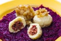 potato dumplings filled with smoked meat with fried onion on red cabbage Royalty Free Stock Photo