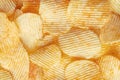 Potato fluted chips close-up. Background of corrugated chips top view Royalty Free Stock Photo