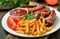 Potato fries and pork ribs Royalty Free Stock Photo