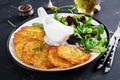 Potato fritters/draniki/pancakes served with sour cream. Royalty Free Stock Photo