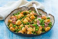 Potato gnocchi with green peas, pesto, proscuitto and chorizo