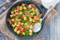 Potato gnocchi with green peas, pesto, proscuitto and chorizo