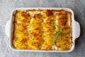 Potato gratin - graten baked potatoes with cream and cheese with rosemary and forks Turkish name; Kremali patates