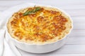 Potato gratin - graten (baked potatoes with cream and cheese) with rosemary and forks (Turkish name Kremali patates