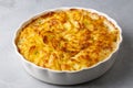 Potato gratin - graten (baked potatoes with cream and cheese) with rosemary and forks (Turkish name Kremali patates