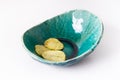 Potato grooved chips in a homemade ceramic plate turquoise on a white background