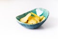 Potato grooved chips in a homemade ceramic plate turquoise on a white background