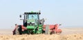 A tractor and wind rower harvesting Idaho potatoes.