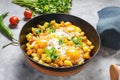 Potato hash with eggs and herbs for breakfast on concrete background Royalty Free Stock Photo