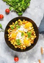 Potato hash with eggs and herbs for breakfast on concrete background Royalty Free Stock Photo