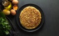 Potato omelet on dark wooden background, zenith view - image Royalty Free Stock Photo