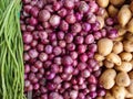 Potato, onion and beans on shop`s display. Long beans, red onion and golden potato composition.