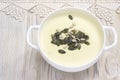 Potato and onion vegan, vegetarian healthy cream soup with pumpkin and sunflower seeds, white bowl. Tasty potato soup and handmade Royalty Free Stock Photo