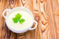 Potato and onion vegan, vegetarian healthy cream soup in white bowl. Tasty potato soup with a leaf of parsley, rustic wooden table Royalty Free Stock Photo