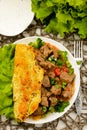 Potato pancake with goulash on wooden table. Royalty Free Stock Photo