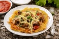 Potato pancake with goulash on wooden table. Royalty Free Stock Photo